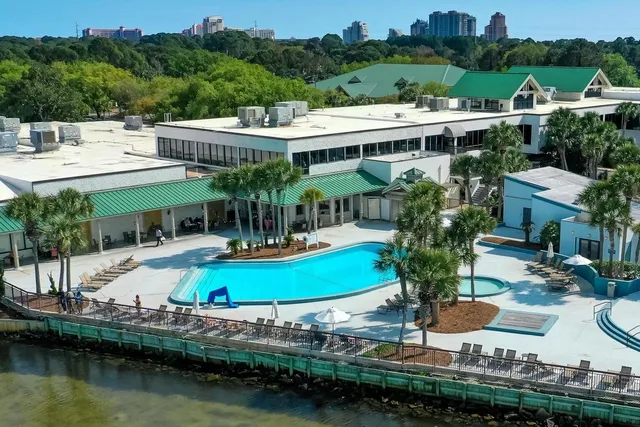 a view of a house with pool and chairs