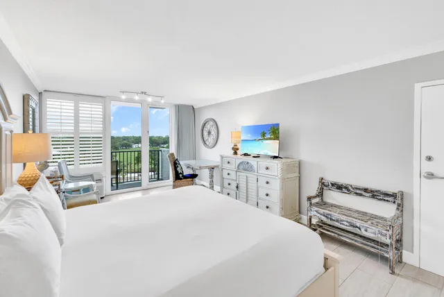 a bedroom with a bed next to a window with the outer view