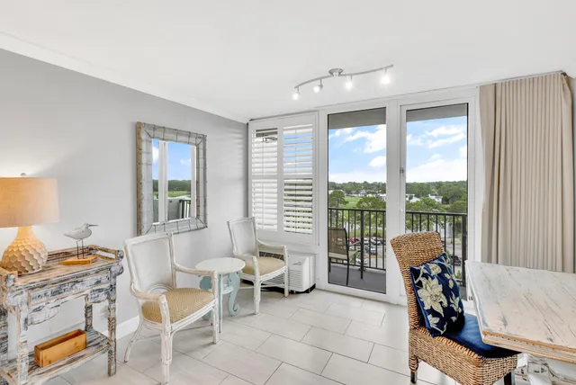 a living room with furniture and large windows