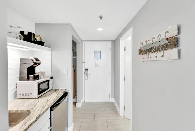a view of a kitchen from a hallway