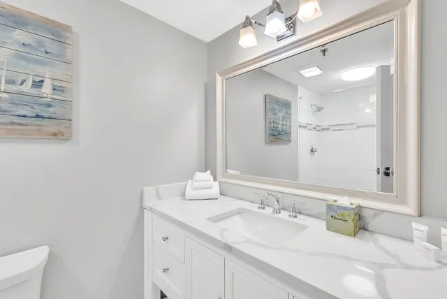 a bathroom with a sink vanity and mirror