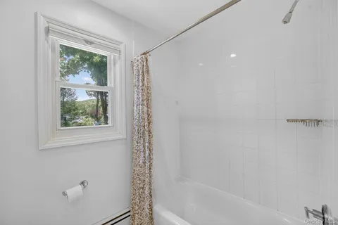 a bathroom with a window and a shower