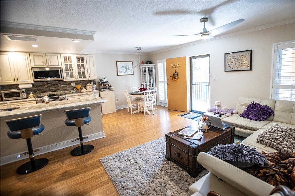 8911 Blind Pass Road, Unit 220 St. Pete Beach, FL 33706 - Photo 22 of 67 a living room with furniture and wooden floor