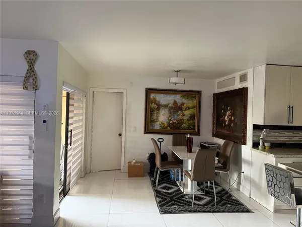 a dining room with furniture and a flat screen tv