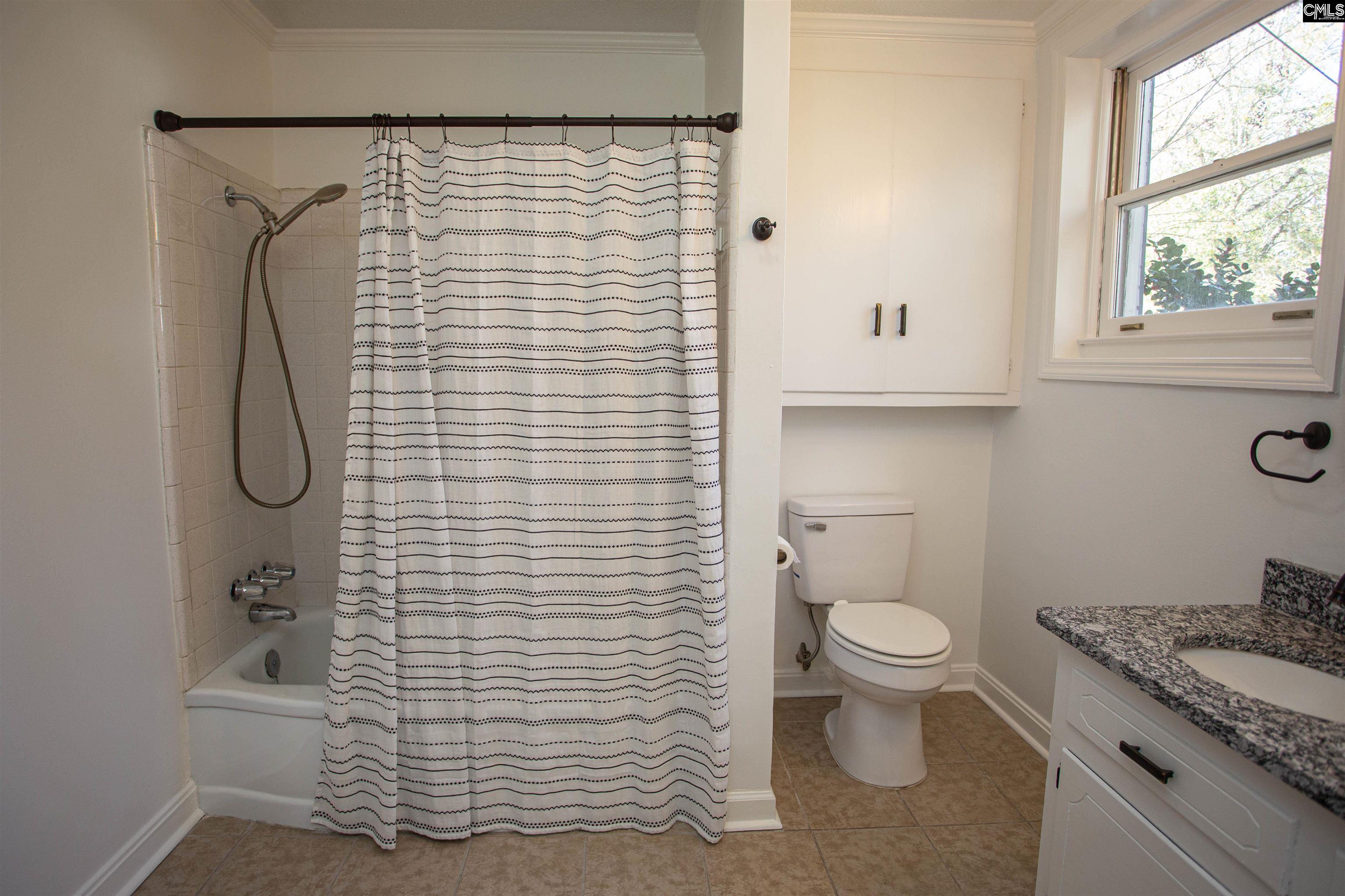 1700 Broad Street Camden, SC 29020 - Photo 20 of 41 a bathroom with a granite countertop white toilet and a shower curtain