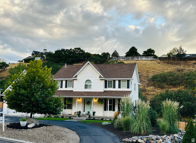 387 North Loafer Canyon Road Payson, UT 84651 - Photo 1 of 94 Traditional two-story residence with white siding and dark shutters, featuring a covered front porch with recessed lighting