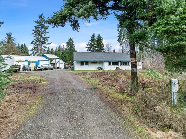 a view of a house with a yard and sitting area