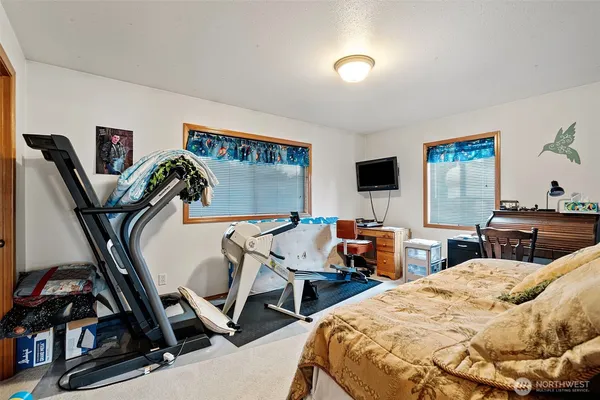 a bedroom with two beds and a desk