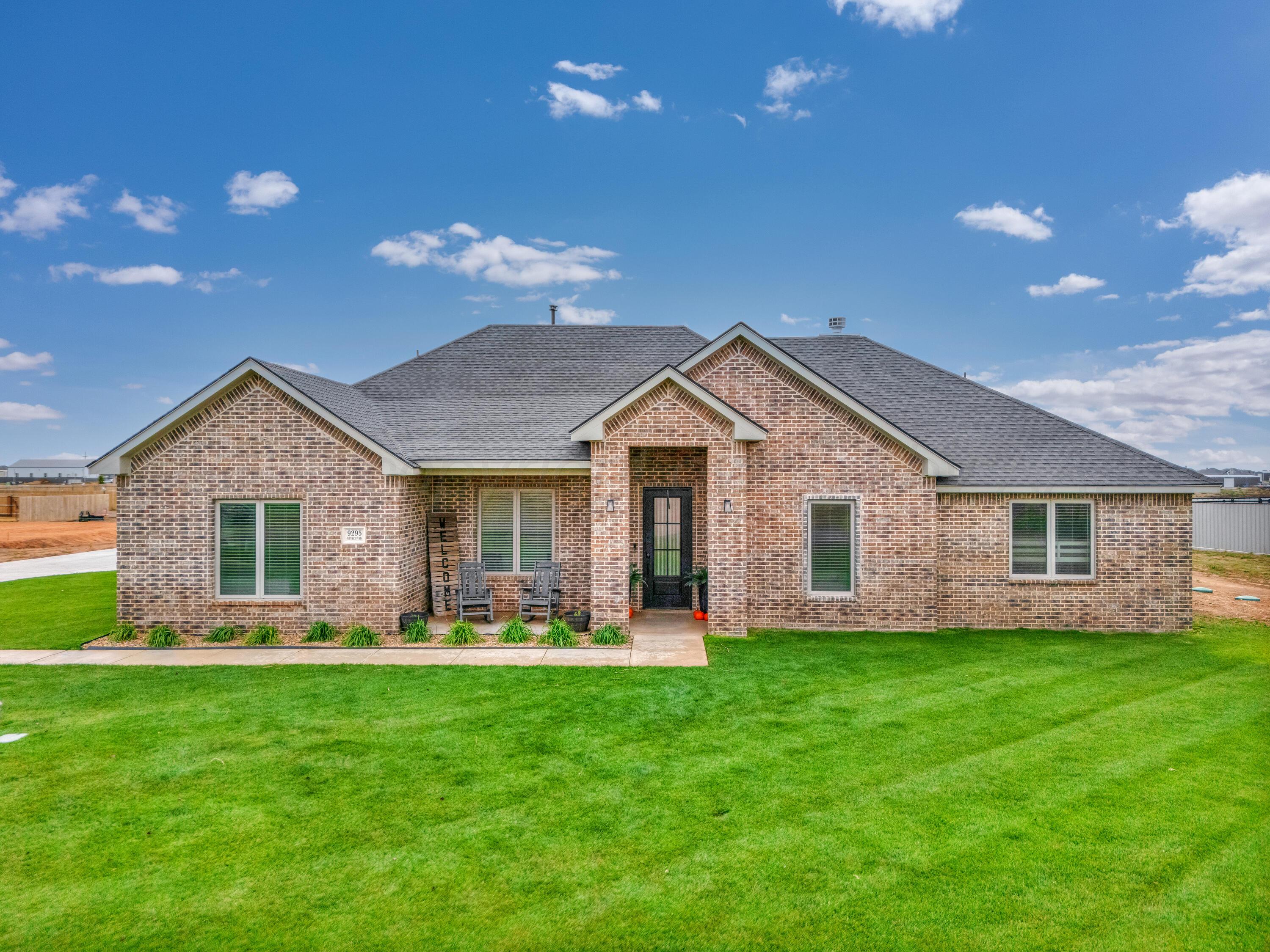 a front view of house with yard and green space