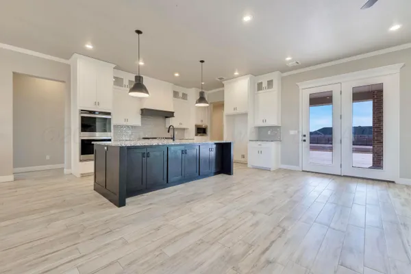 a large kitchen with stainless steel appliances granite countertop a large counter top and oven