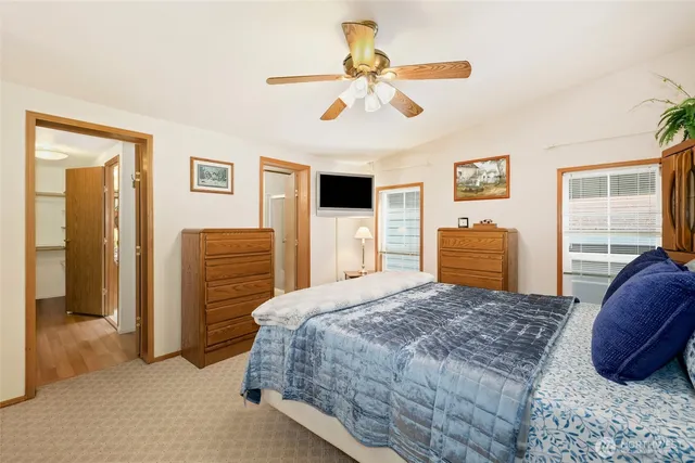 a bedroom with a bed dresser and a window