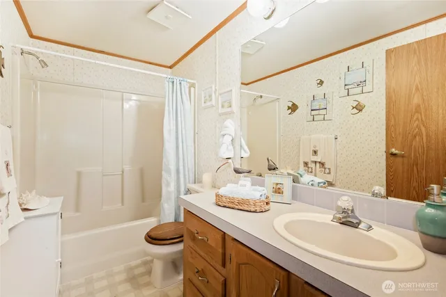 a bathroom with a granite countertop sink a toilet and a mirror