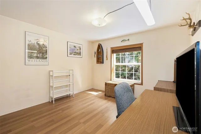 a bed room with a bed tv and a window