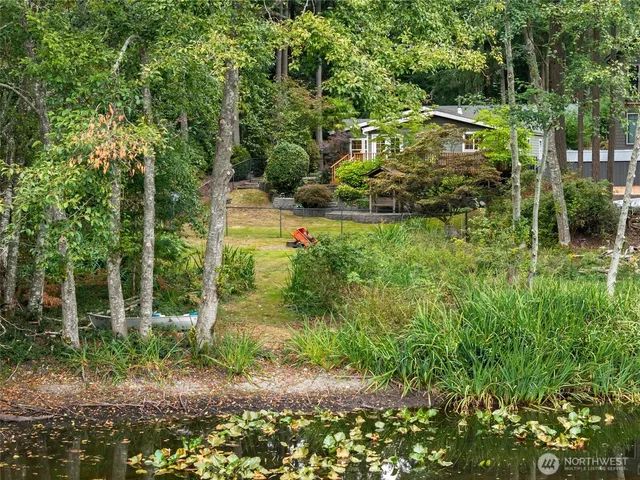 a view of a lake with a yard and mountain