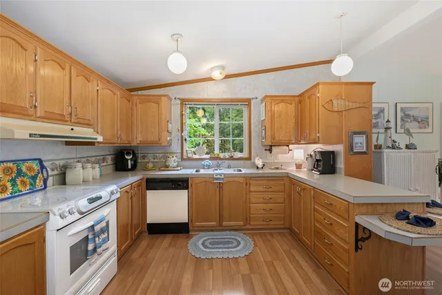 a kitchen with a sink window and cabinets