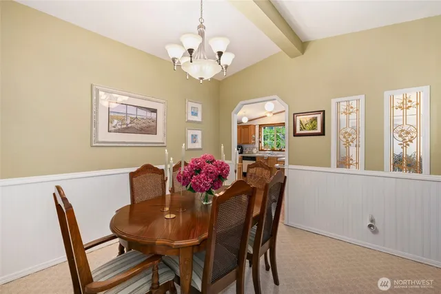 a view of a dining room with furniture and chandelier