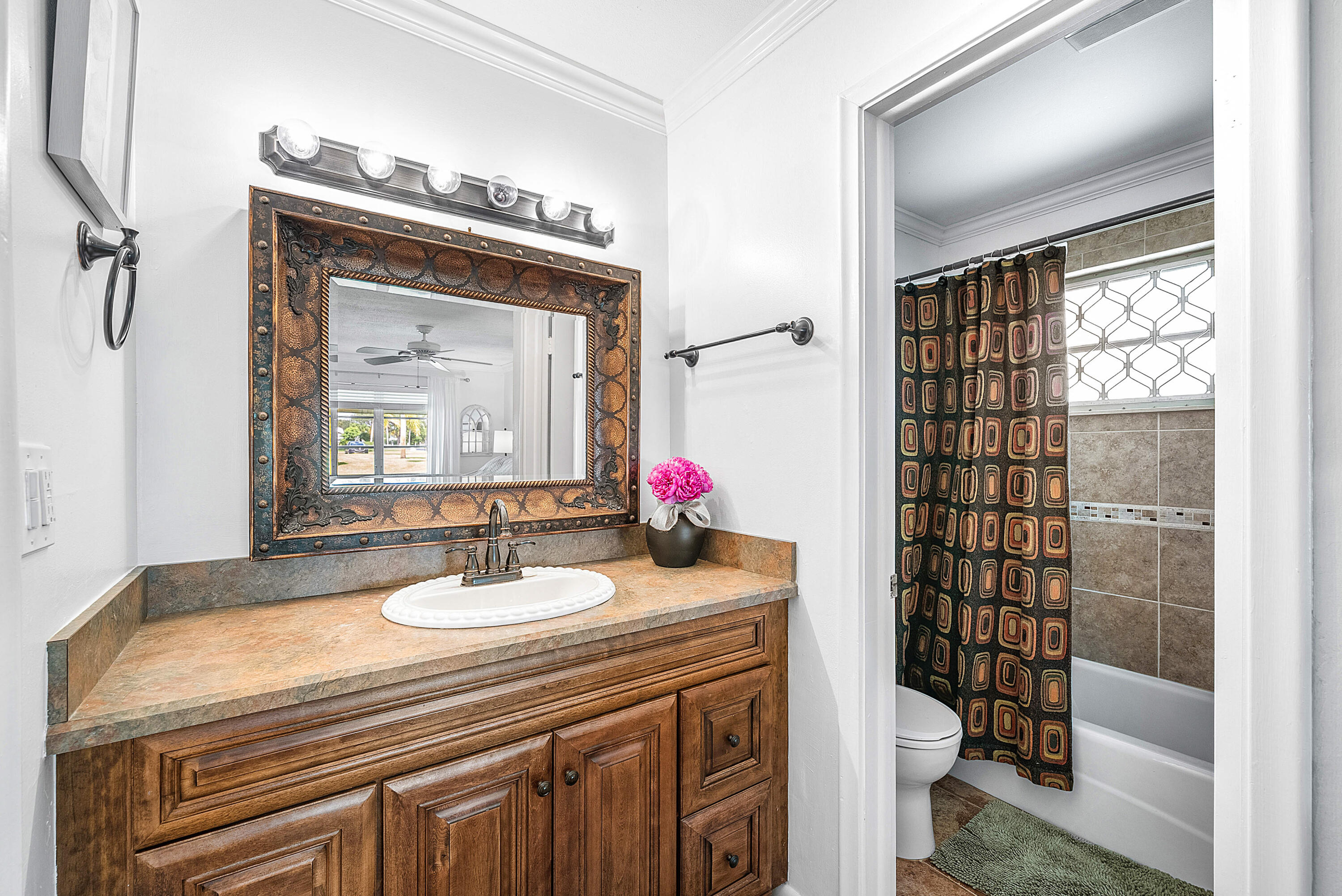 510 High Point Drive, Unit D Delray Beach, FL 33445 - Photo 12 of 23 a bathroom with a sink a toilet and shower