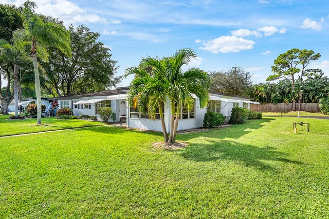 a house view with swimming pool and garden