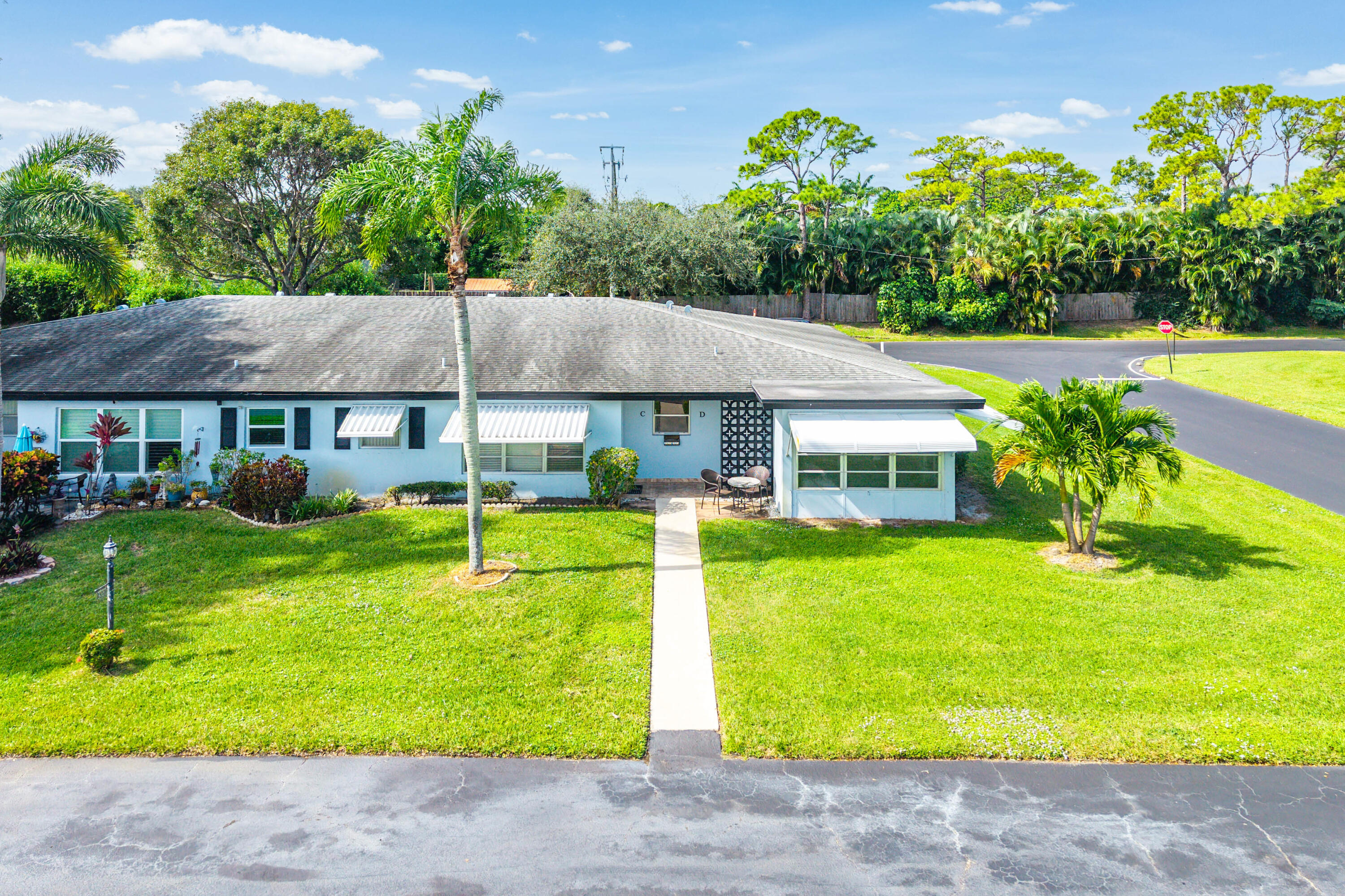 510 High Point Drive, Unit D Delray Beach, FL 33445 - Photo 17 of 23 a view of a house with pool and a yard