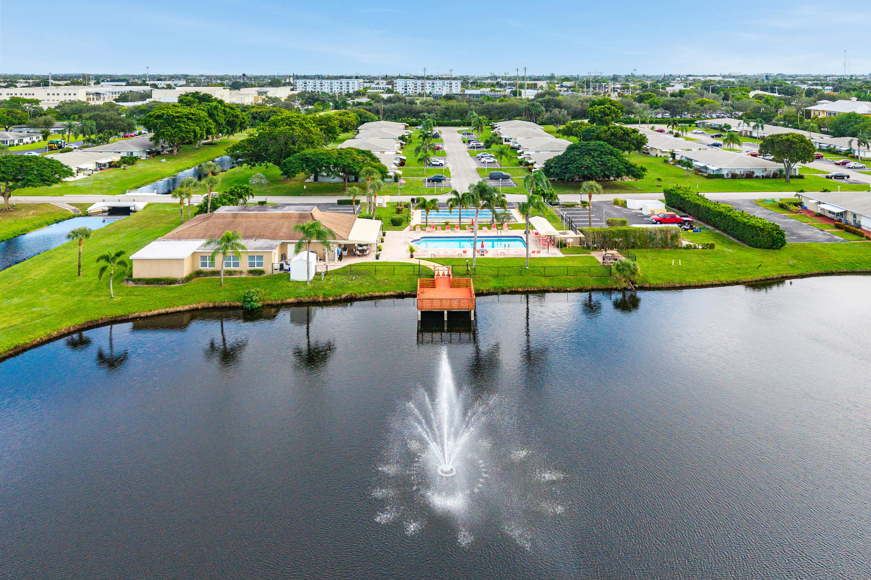 510 High Point Drive, Unit D Delray Beach, FL 33445 - Photo 20 of 23 an aerial view of a house with a garden and lake view