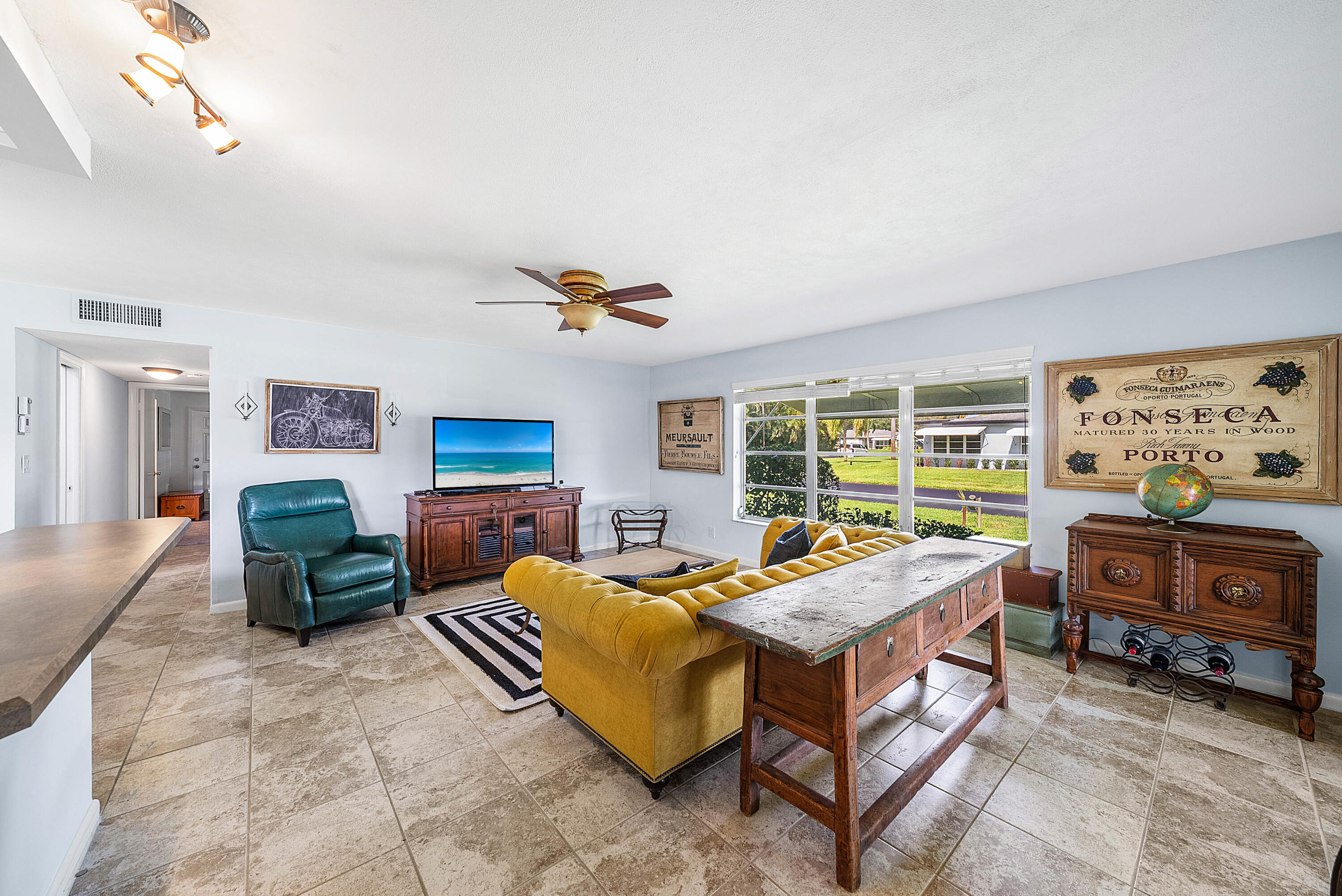 510 High Point Drive, Unit D Delray Beach, FL 33445 - Photo 2 of 23 a living room with furniture and a flat screen tv