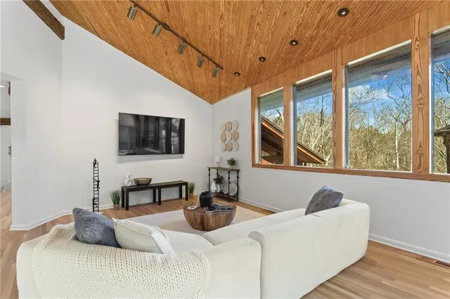 a kitchen with stainless steel appliances granite countertop a refrigerator a stove and a sink with large cabinets