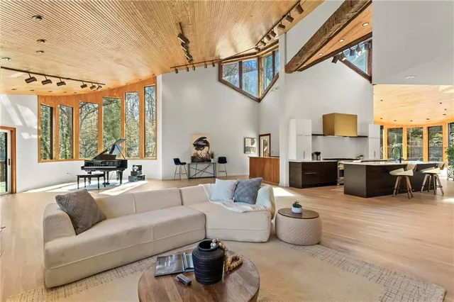a kitchen with a sink and a stove with wooden floor