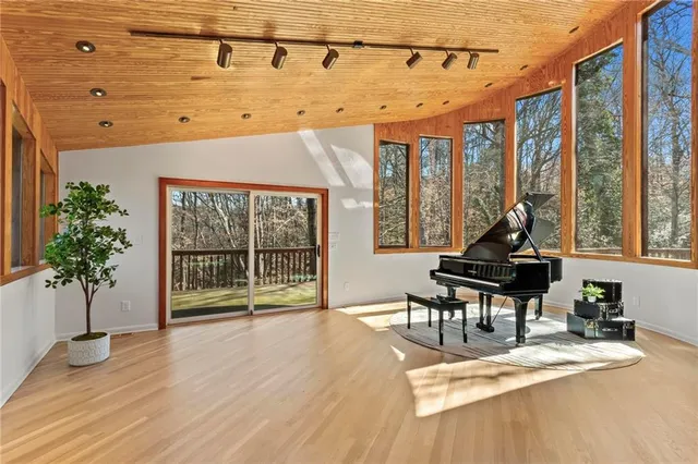 a view of a dining room with furniture large windows and wooden floor