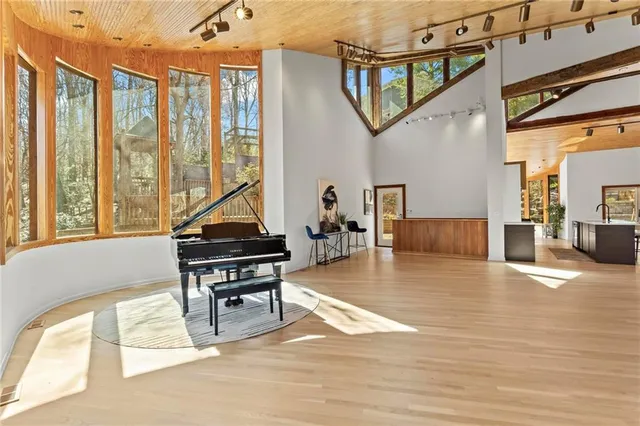 a living room with furniture and a painting on the wall