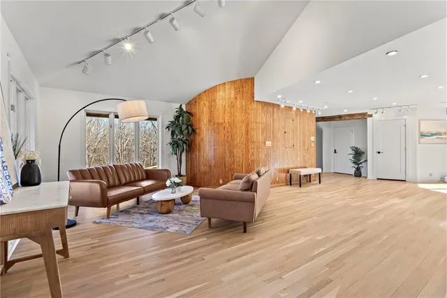 a living room with furniture and a wooden floor