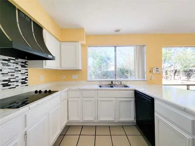 a kitchen that has a sink and a stove