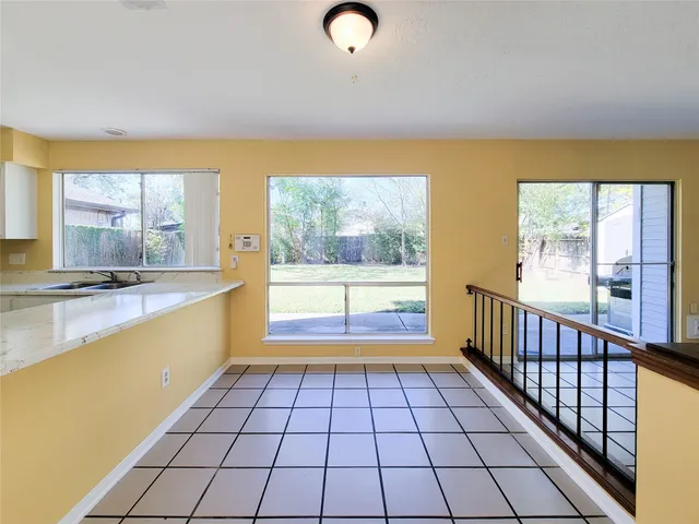 a view of an empty room with a fireplace and a large window