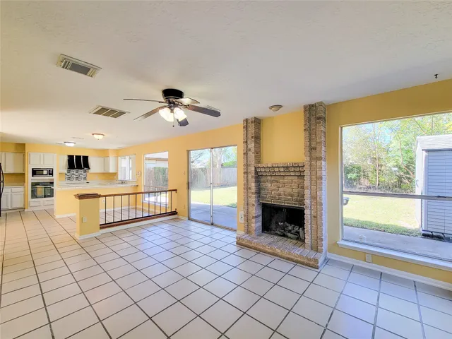 a view of a livingroom with a ceiling fan and window