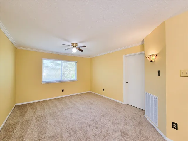 a view of room with window and ceiling fan