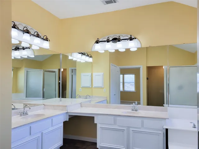a view of an empty room with a ceiling fan and window