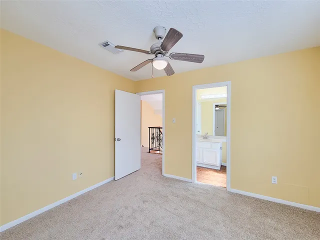 a view of an empty room with a fireplace and a window