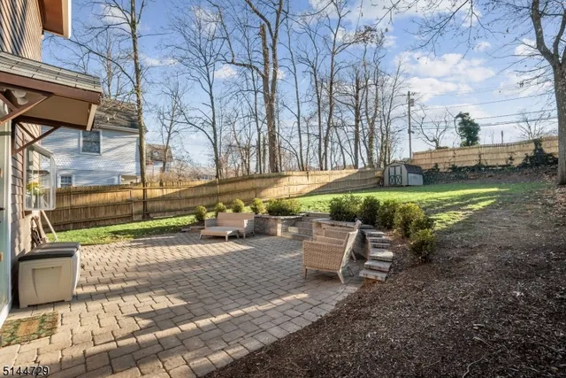 a view of a park with bench and wooden fence