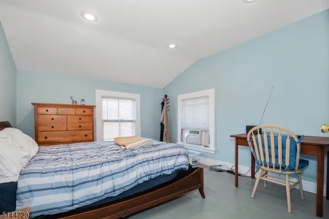 a bedroom with a bed and chair