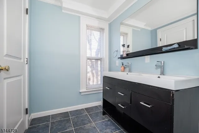 a bathroom with a sink vanity and mirror