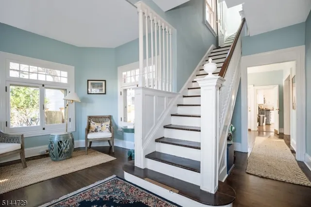 a view of entryway with furniture and wooden floor