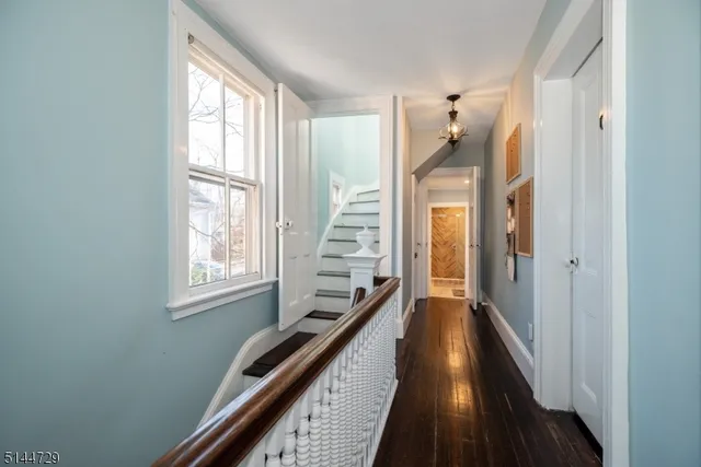 a view of a hallway with windows and stairs