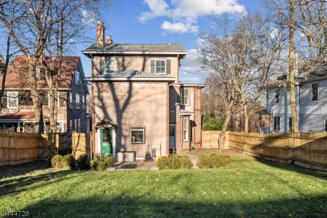 a view of a house with a yard and garage