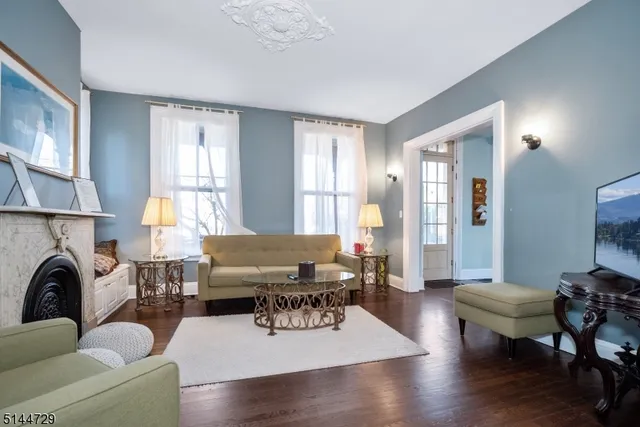 a living room with furniture fireplace and a window