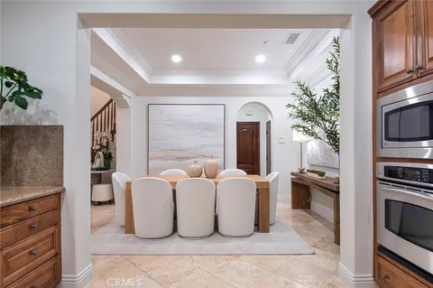 a living room with furniture a large window and a kitchen view
