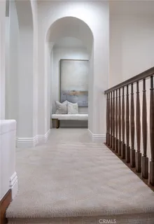 a large white room with a large mirror and couches