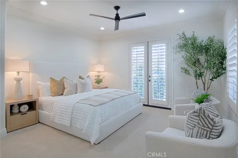 a spacious bedroom with a bed and a potted plant