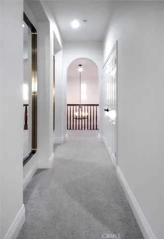 an empty room with windows and stairs