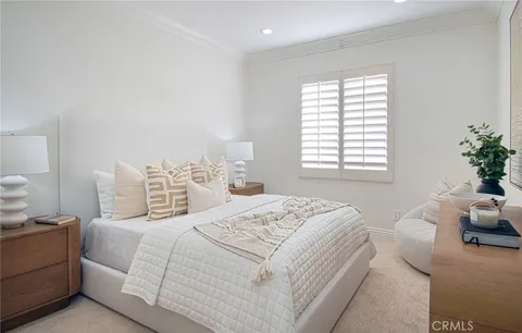 a bedroom with a bed and mirror