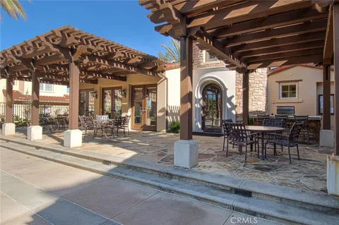 a view of a patio with a table and chairs and potted plants