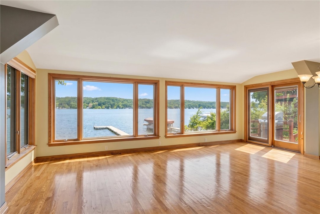 5452 East Lake Road Conesus, NY 14435 - Photo 20 of 42 Expansive living room with stunning sunset views!